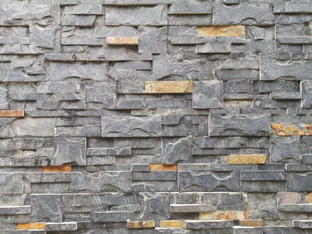 Grey and brown natural stone cladding with golden accents