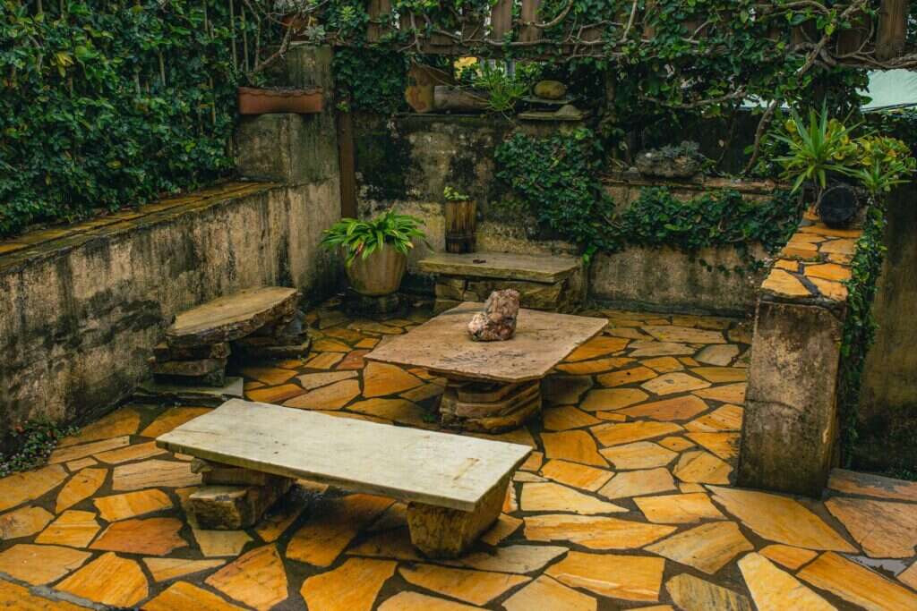 Flagstone patio with a stone table and benches