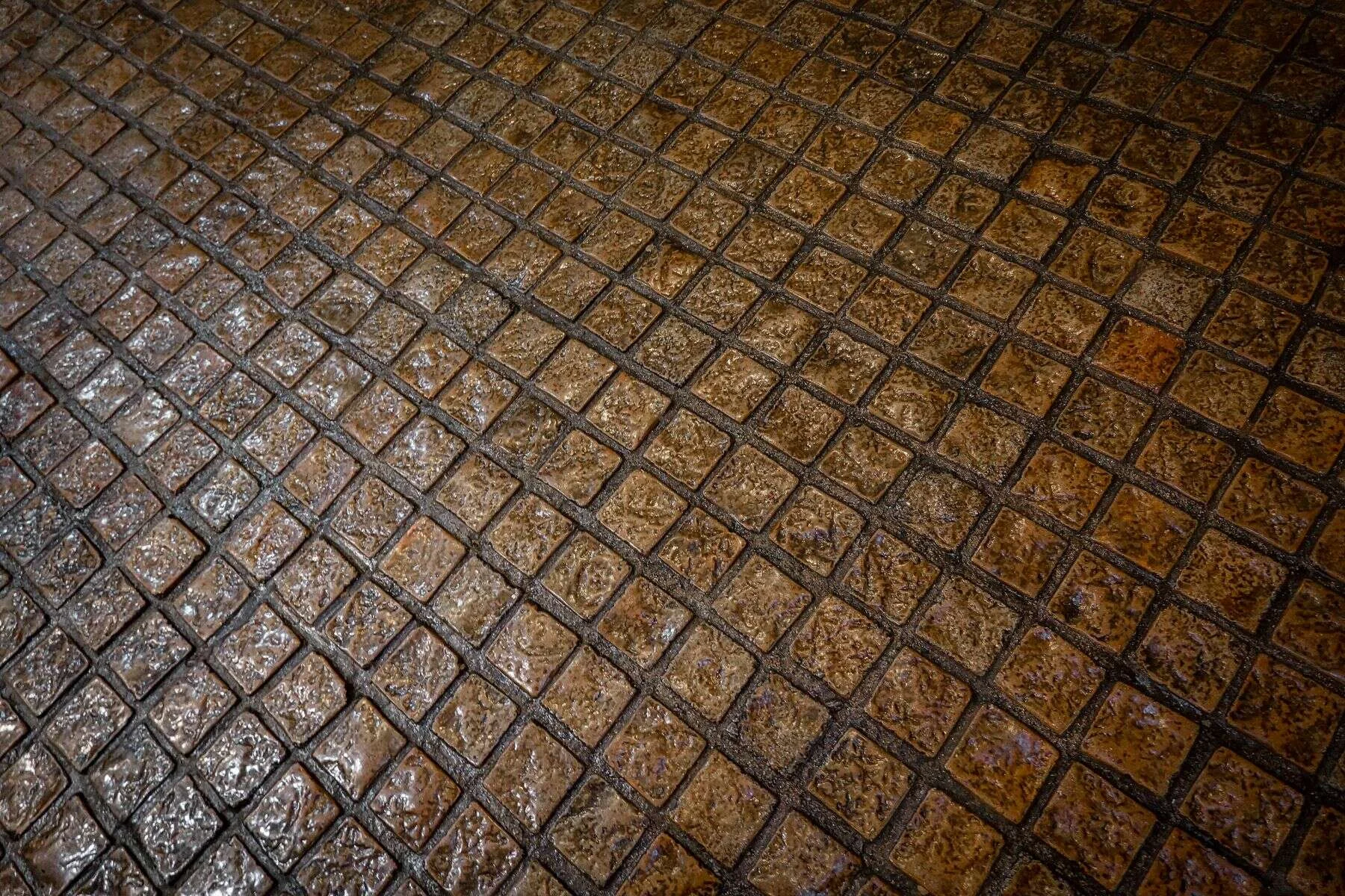 Wet cobblestones with warm reflections