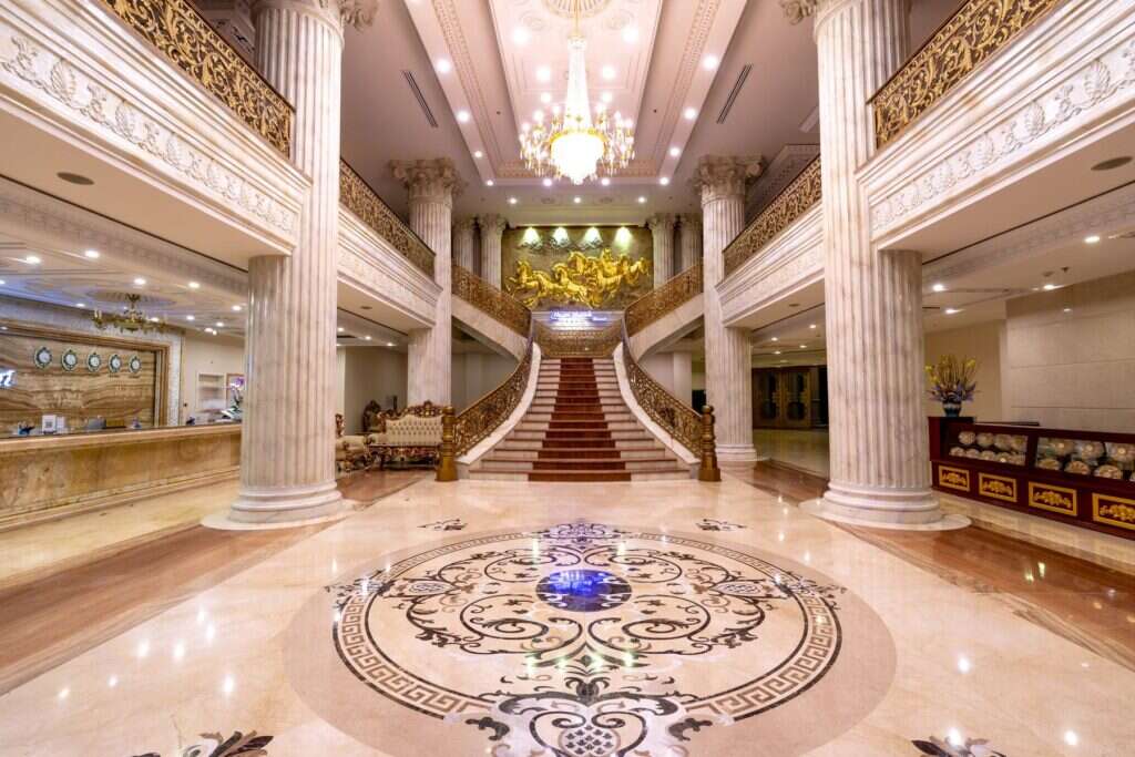 Hotel foyer with an inlaid marble floor and grand staircase