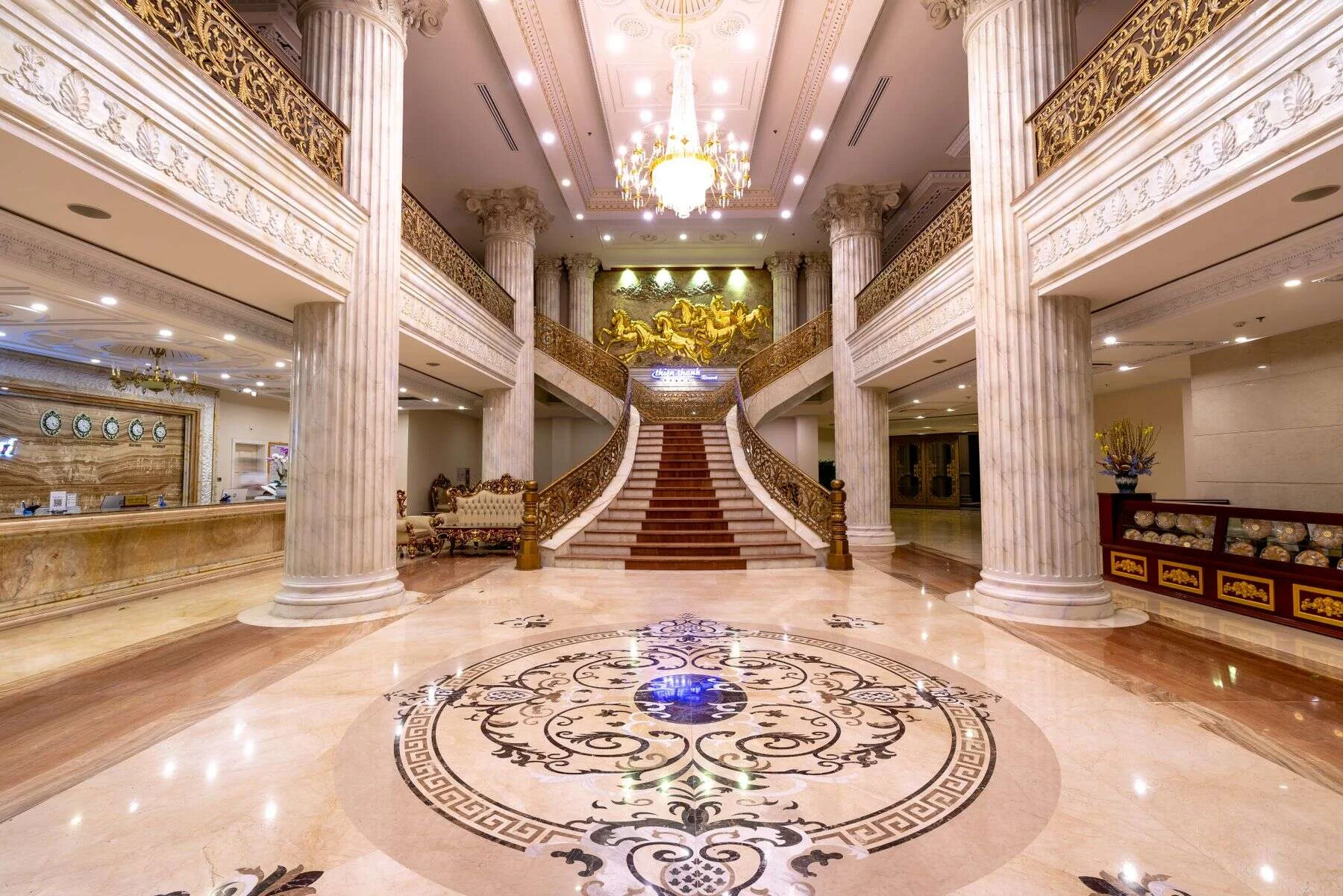 Hotel foyer with an inlaid marble floor and grand staircase