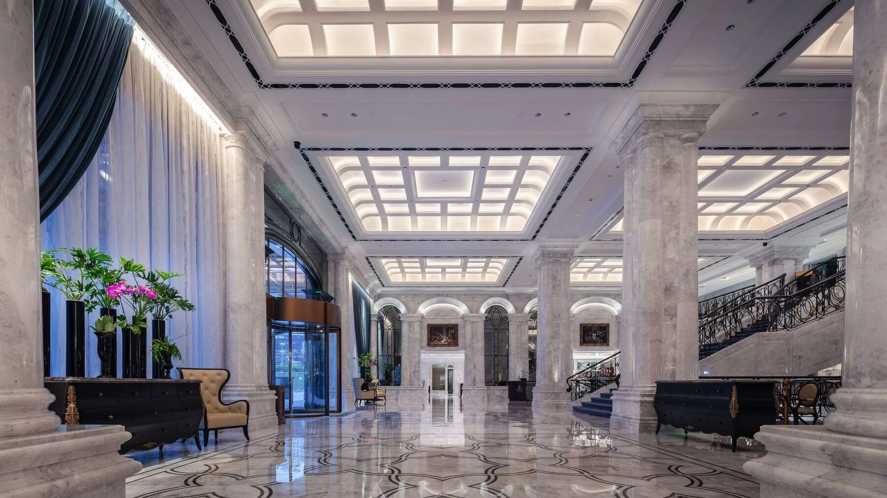 Ornate hotel lobby with a polished stone floor