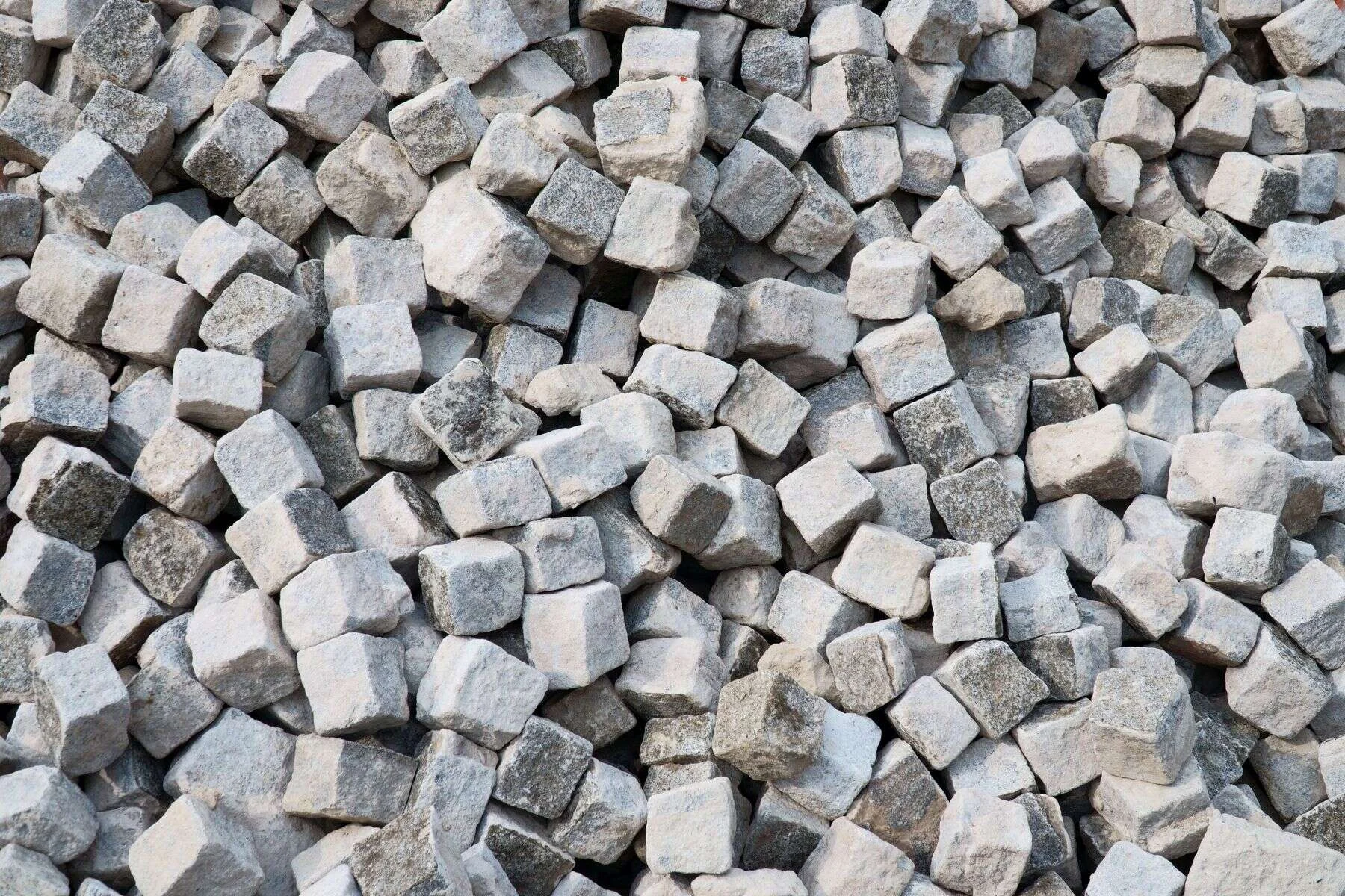 Heap of grey granite cobblestones