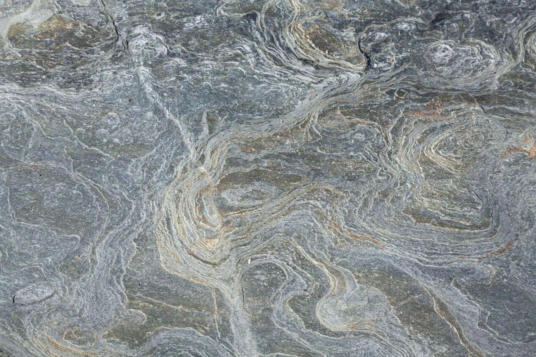 Grey quartzite surface with flowing bands