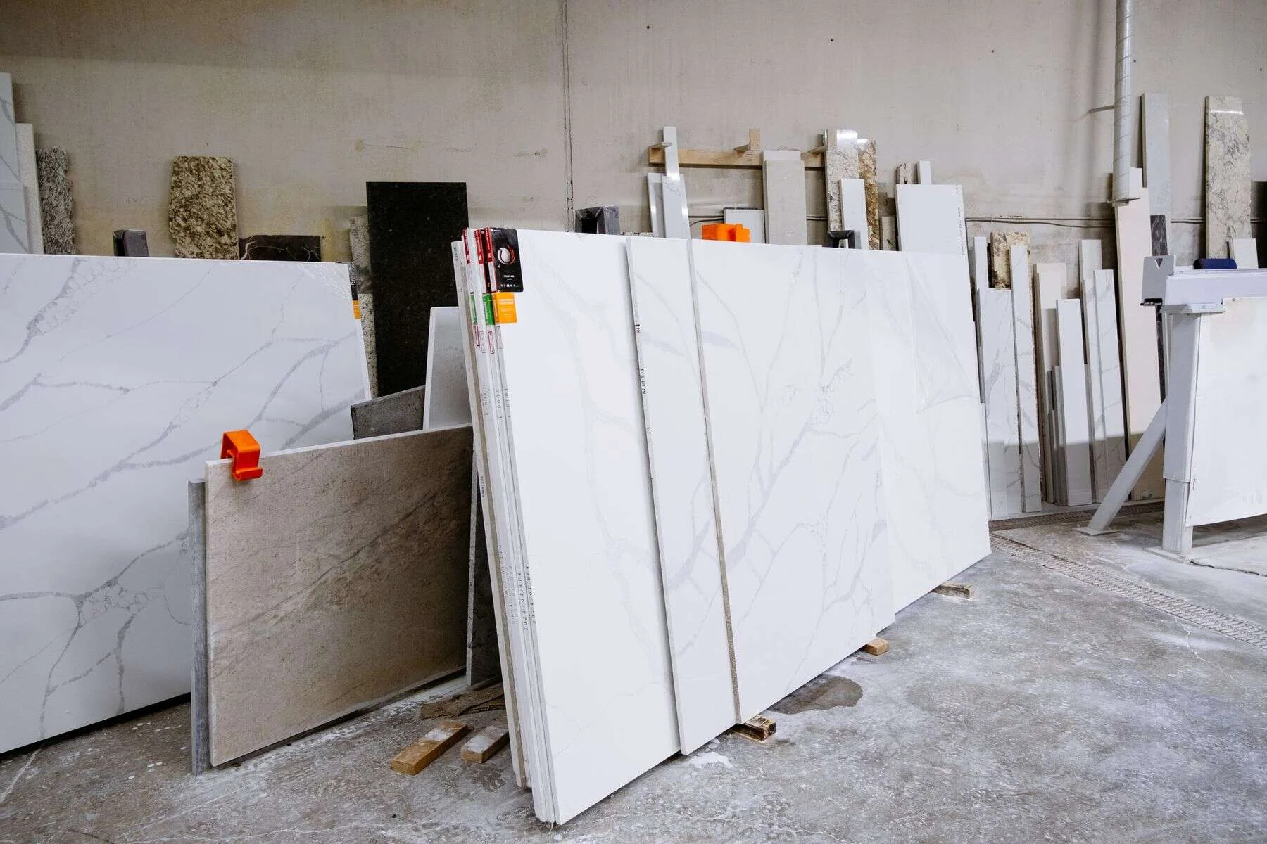 Granite and marble slabs standing in a stone processing warehouse