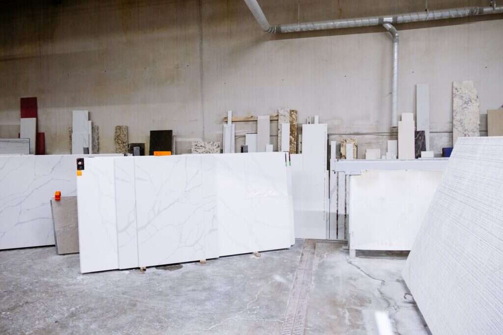 Polished stone slabs lined up inside a stone factory