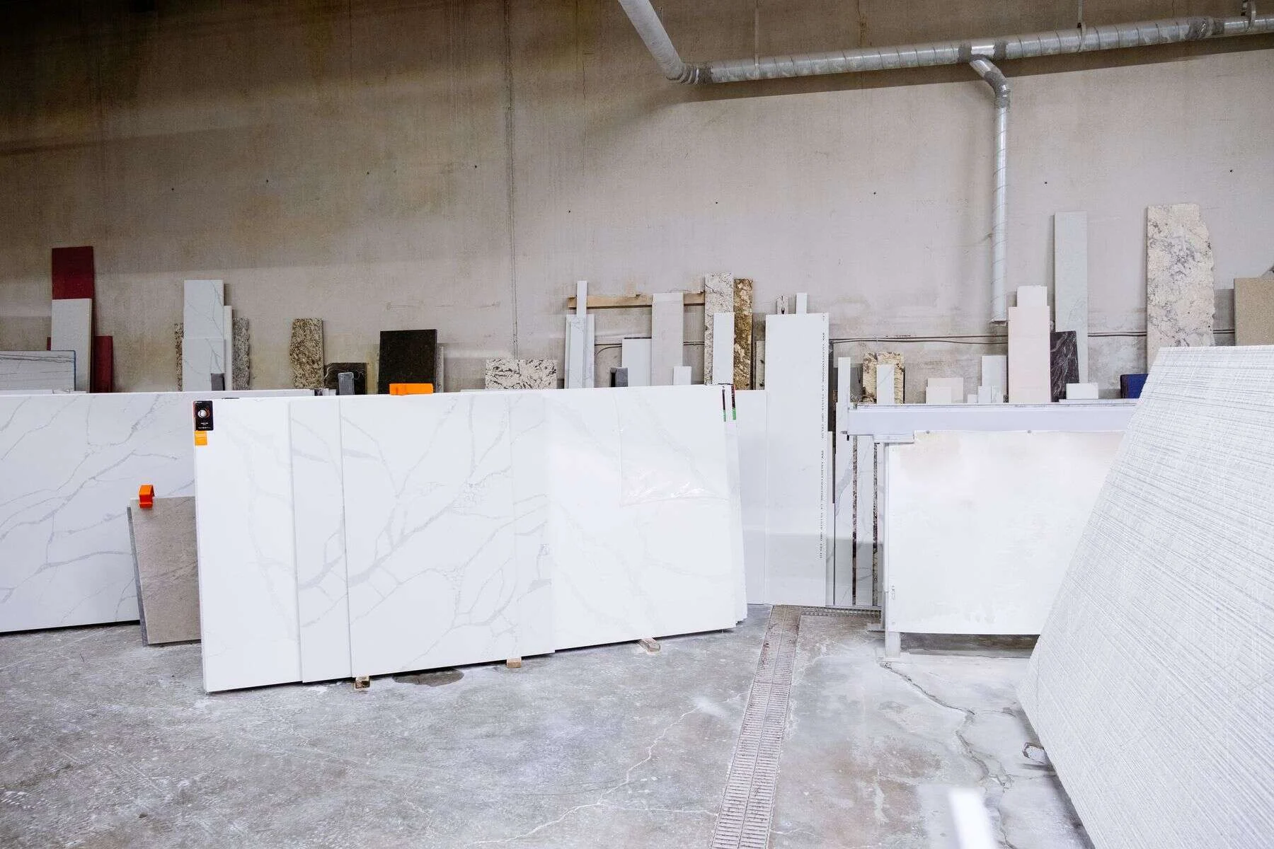 Polished stone slabs lined up inside a stone factory