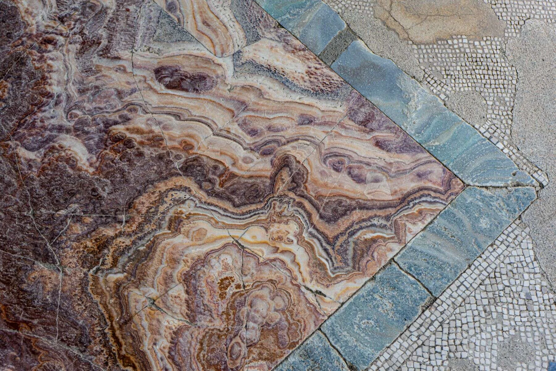 Colourful onyx and marble flooring with mosaic border
