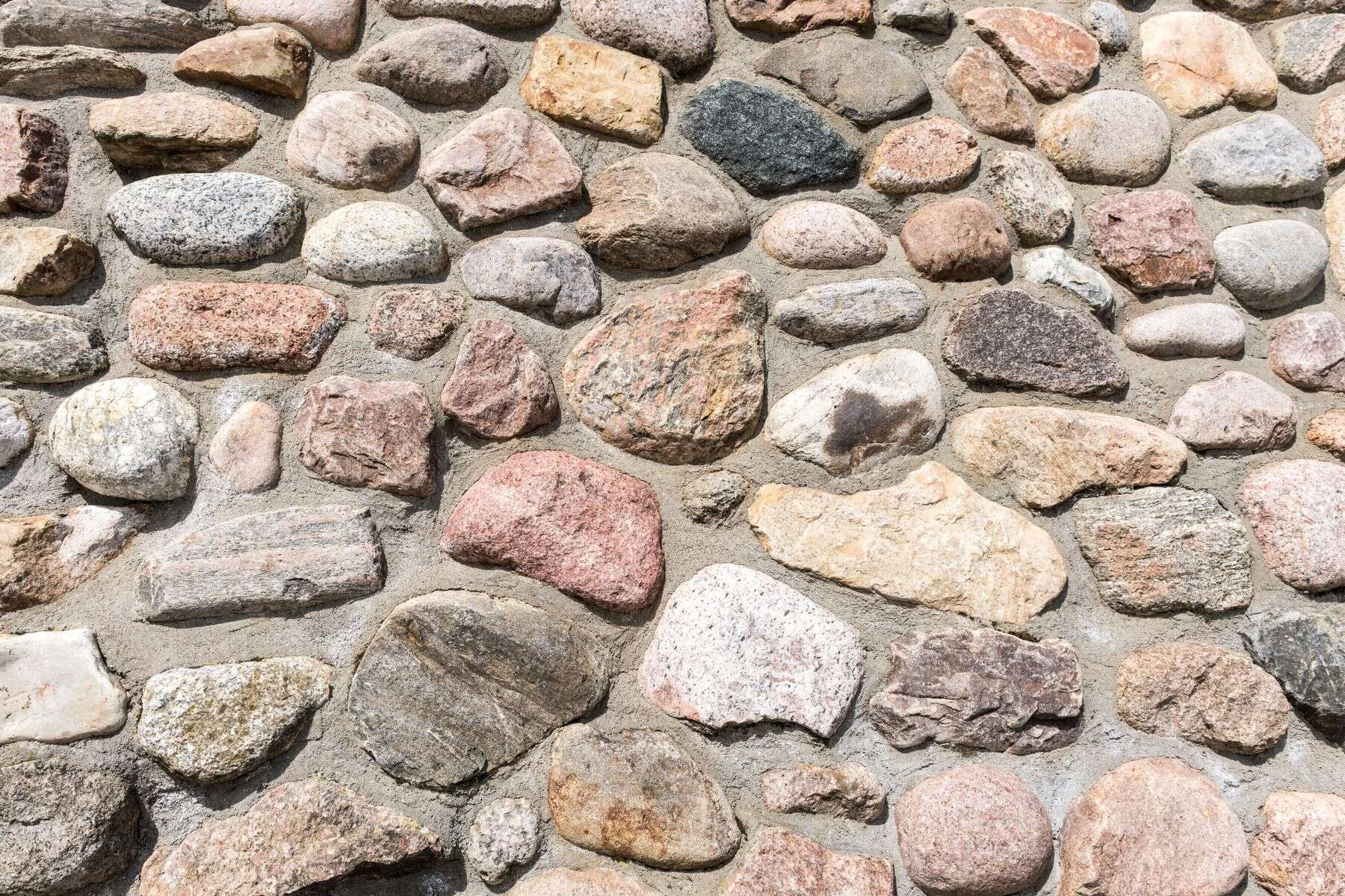 Round fieldstone wall in many natural colours