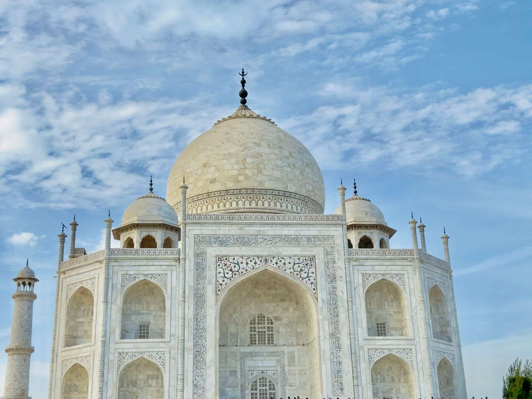 Taj Mahal under a blue sky with clouds