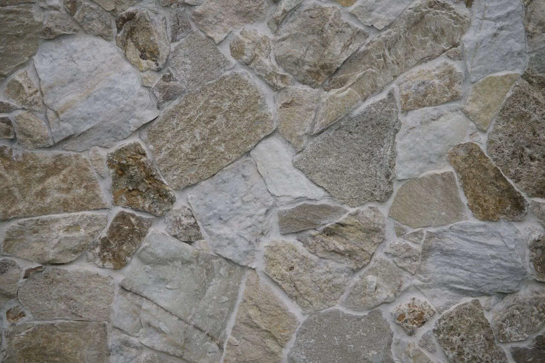 Textured natural stone wall with a random pattern