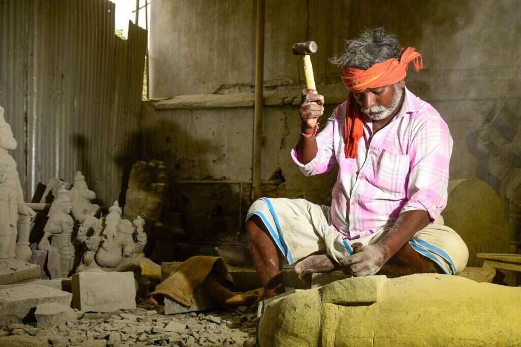 Stone carver working with a hammer