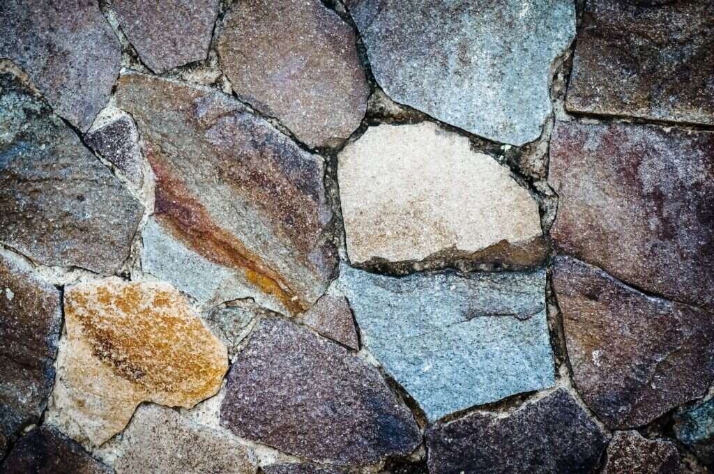 Colourful natural stone wall in blue, brown and cream