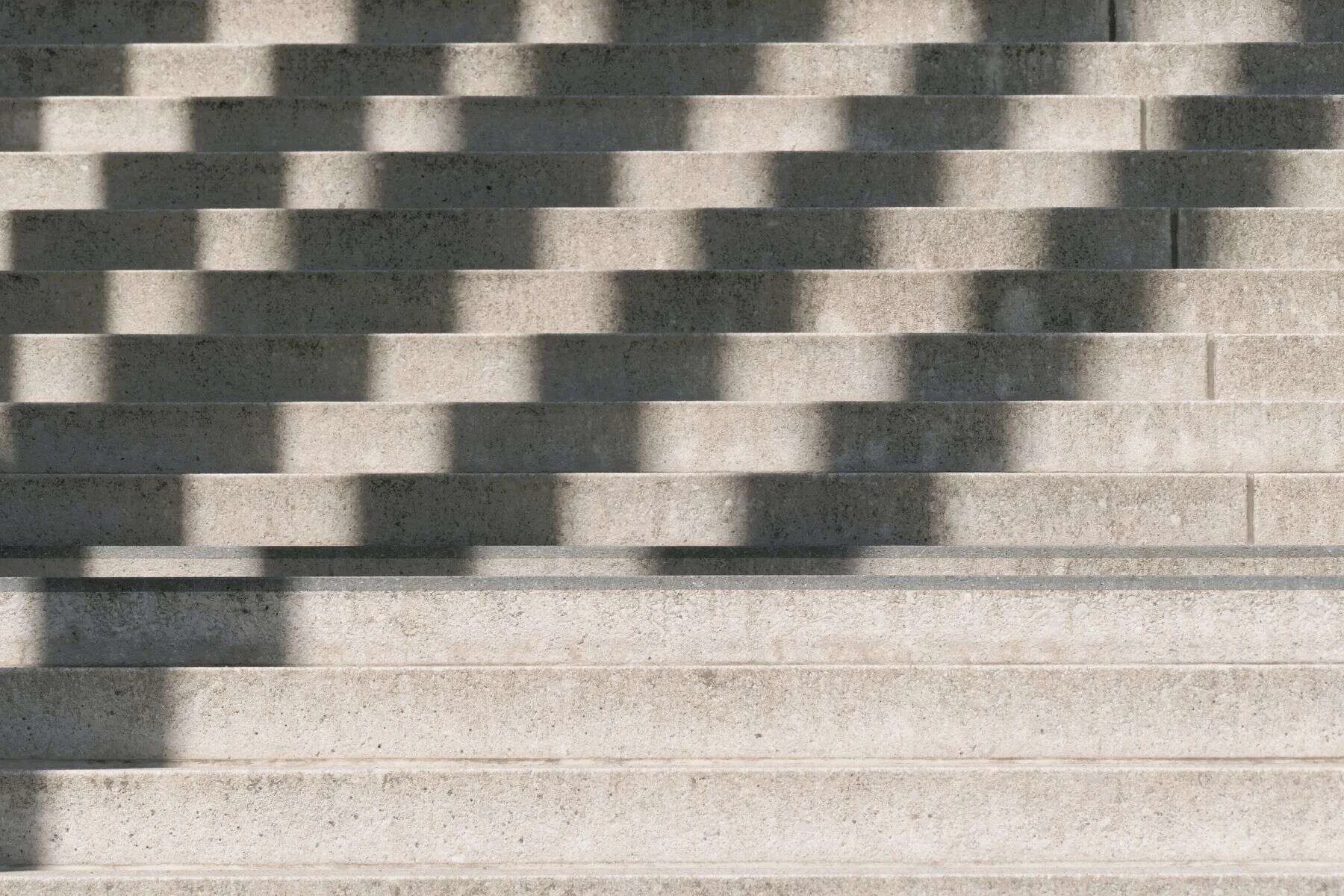 Wide stone stairs with strong shadows