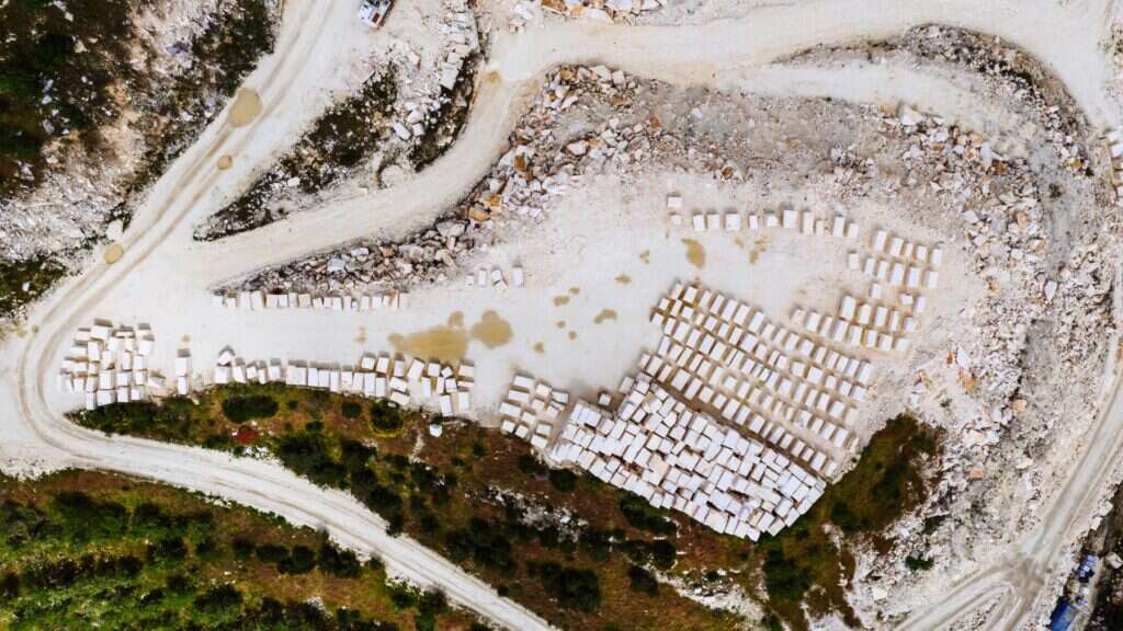 Aerial view of a marble quarry with rows of cut marble blocks