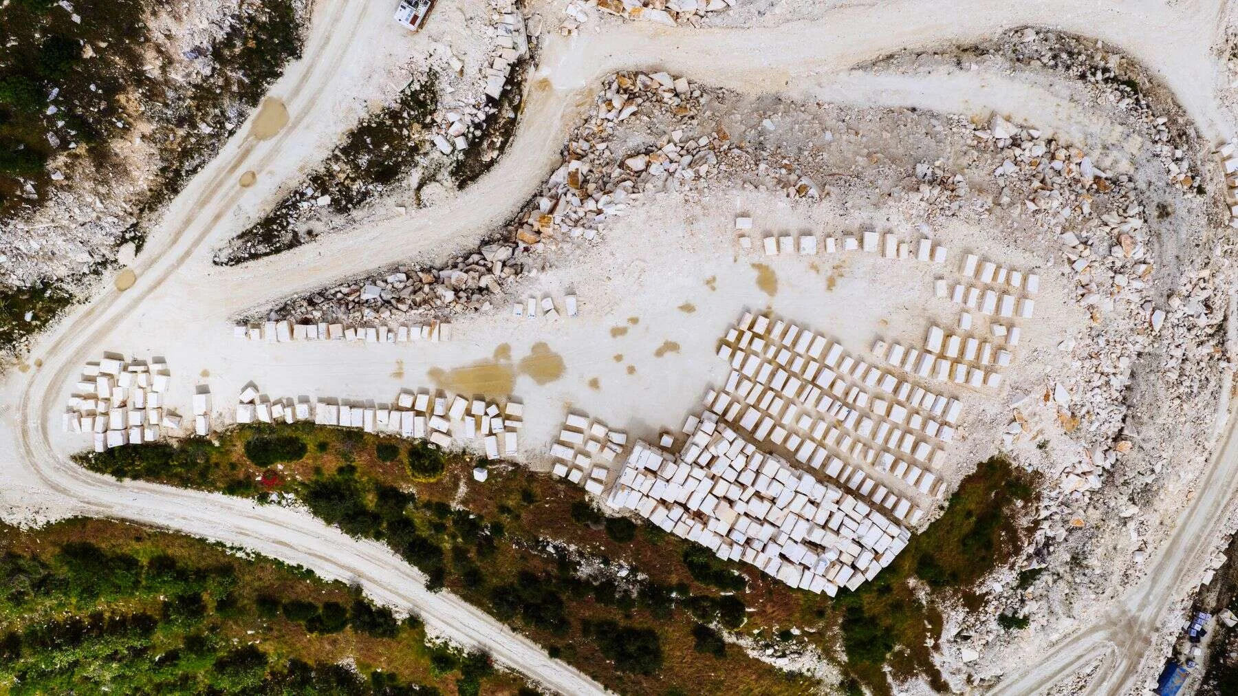 Aerial view of a marble quarry with rows of cut marble blocks