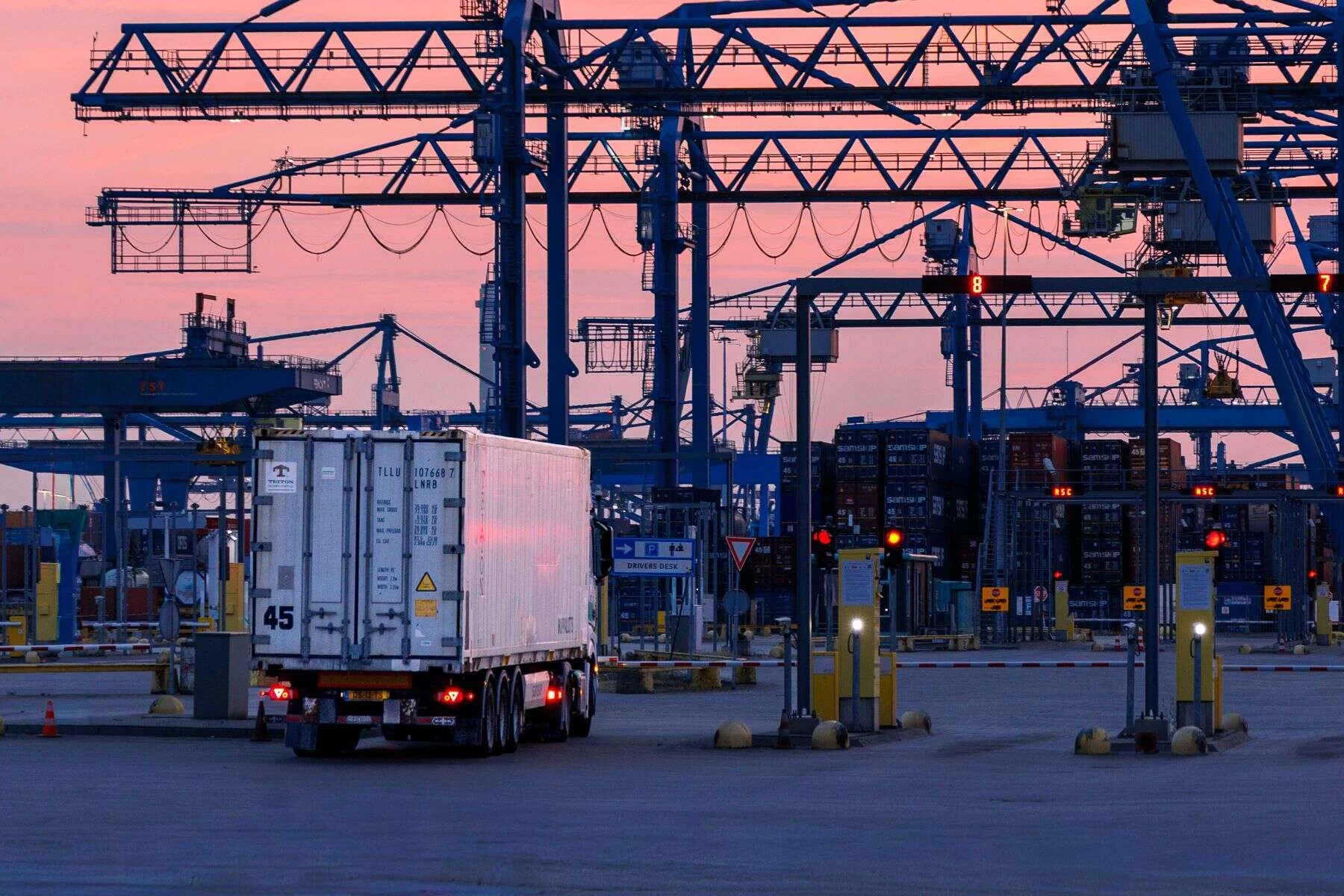 Gantry cranes and a truck at a shipping port