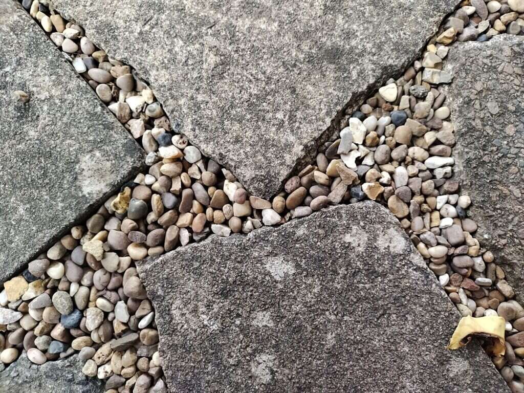 Stone paving slabs with pebbles between them