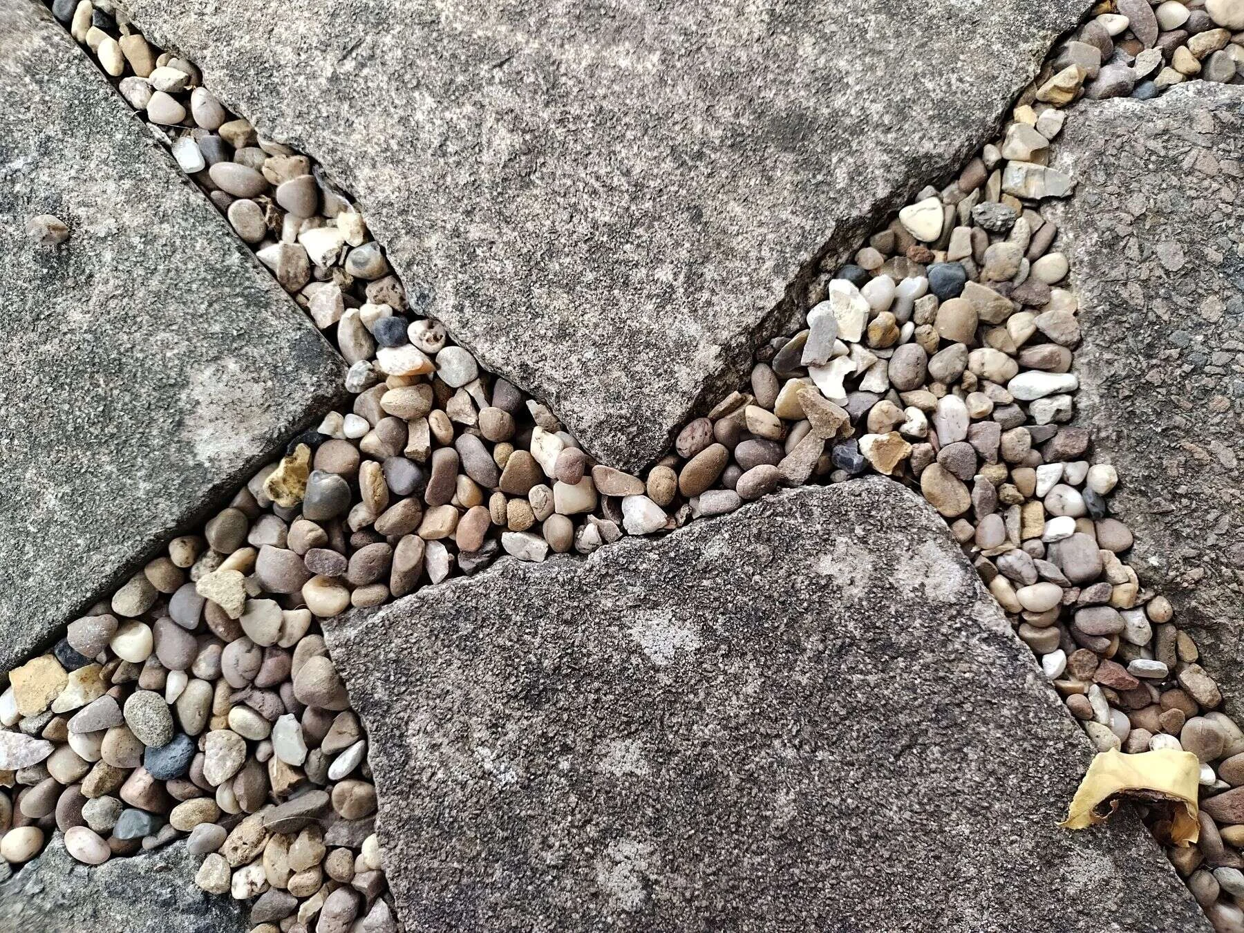 Stone paving slabs with pebbles between them