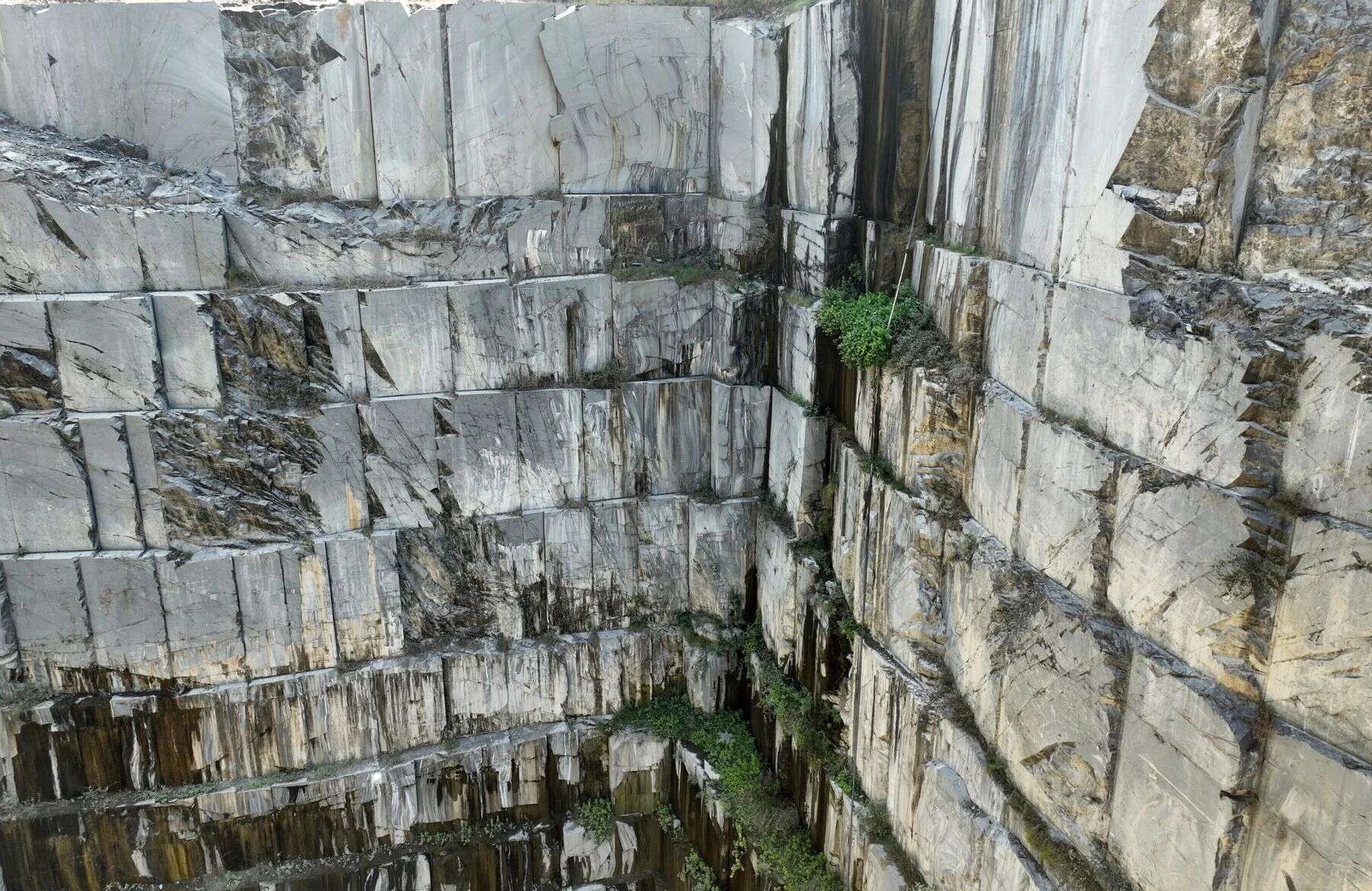 Aerial view of a granite quarry with tall cut stone walls