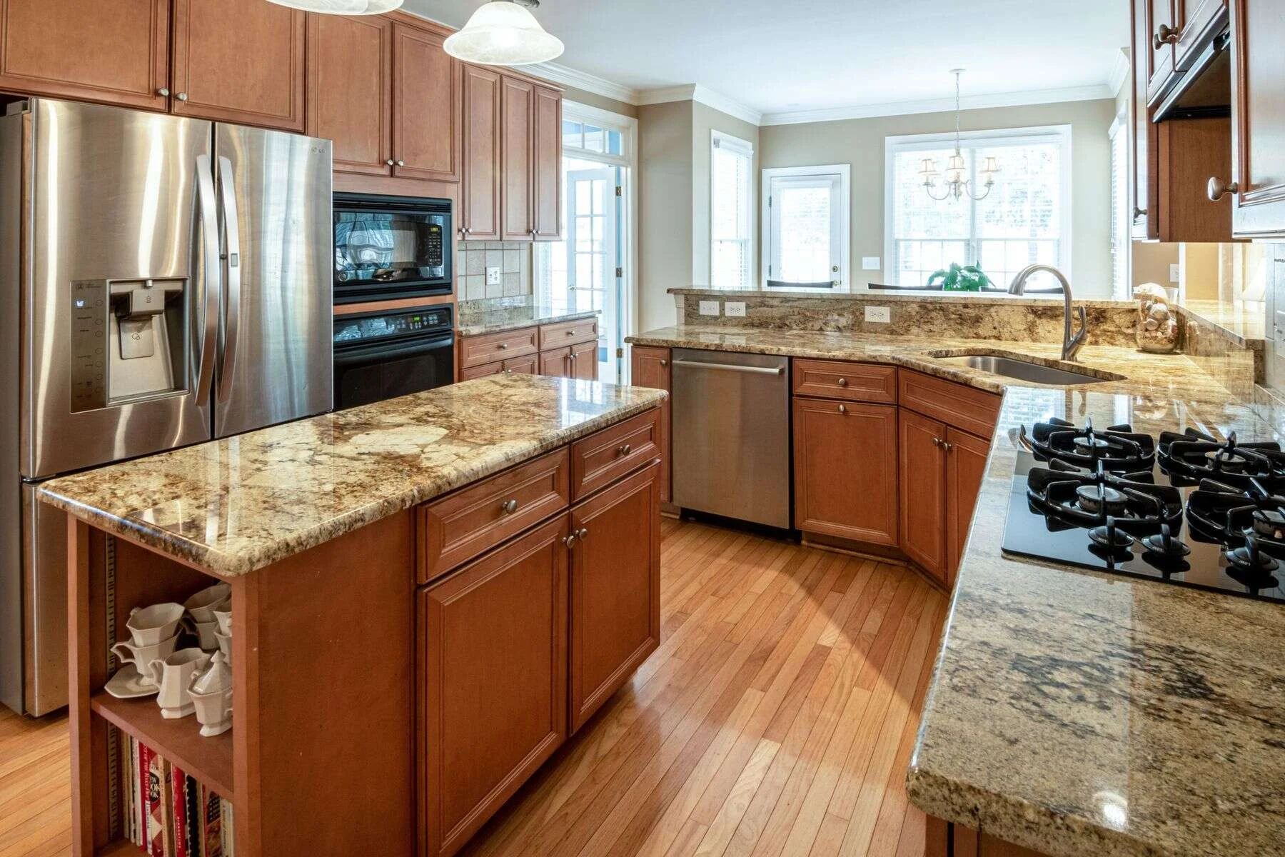 Golden granite kitchen island with a gas hob