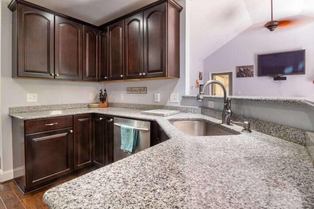Modern kitchen with a granite countertop and dark cabinets