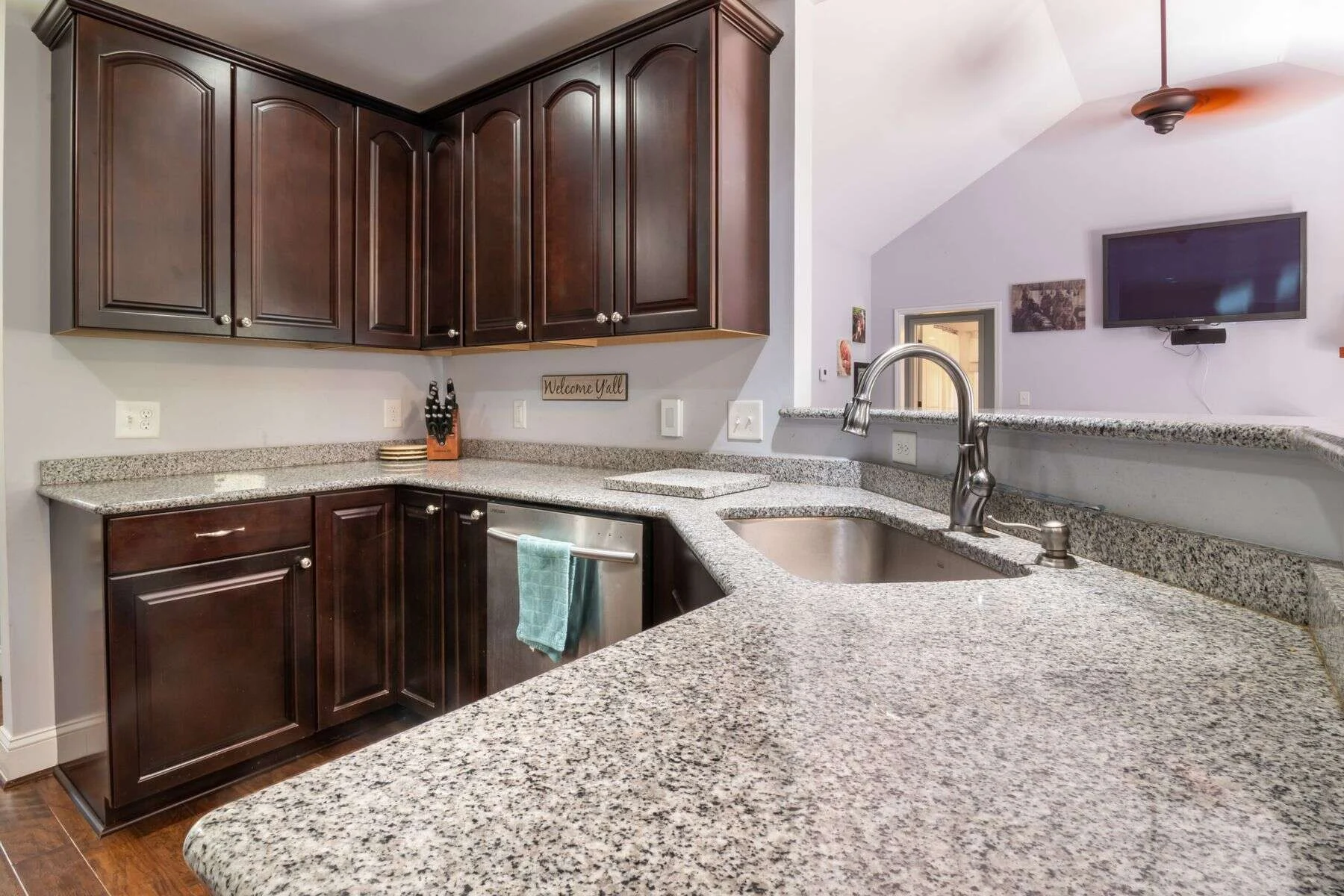 Modern kitchen with a granite countertop and dark cabinets