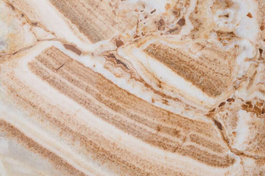 Brown and white banded onyx stone surface