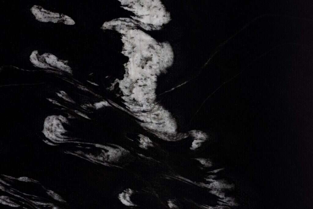 Black stone surface with bold white veins