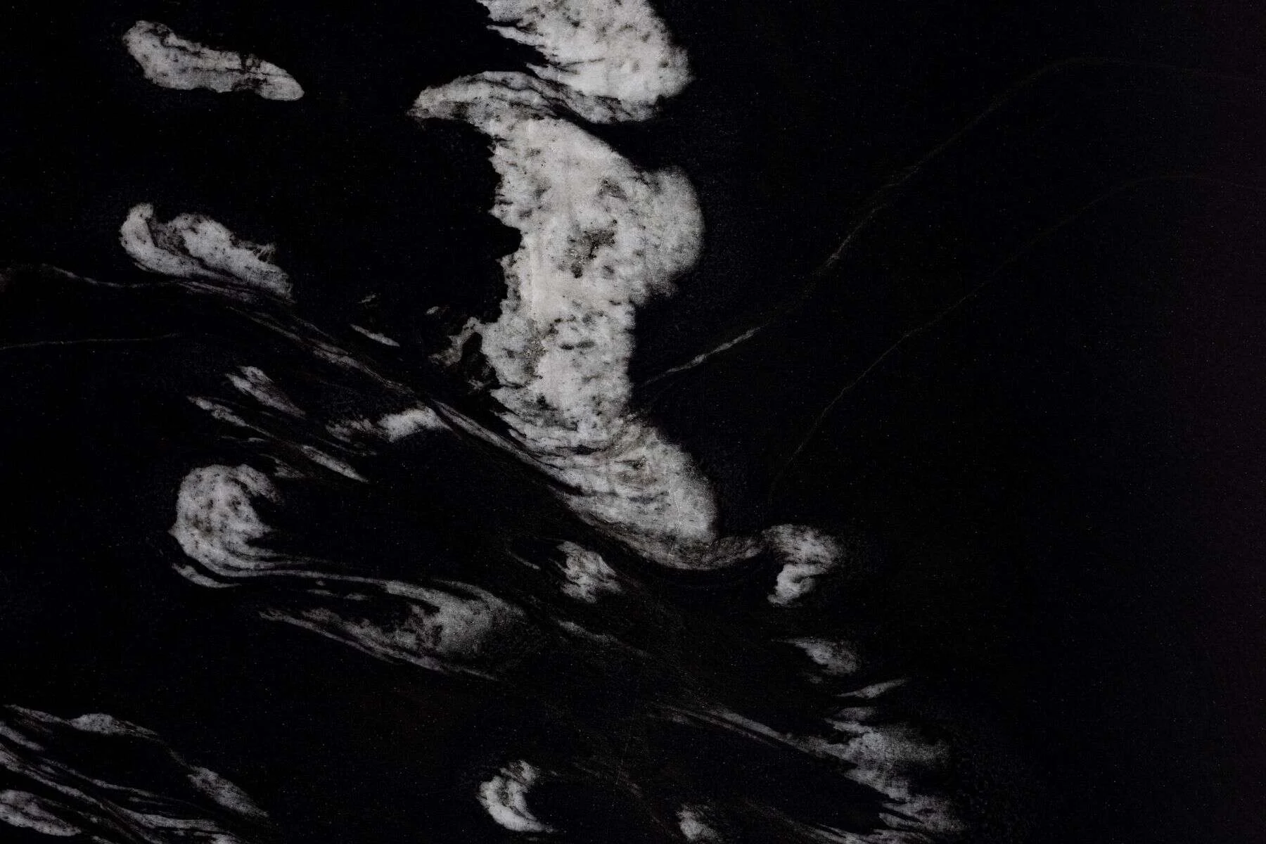 Black stone surface with bold white veins