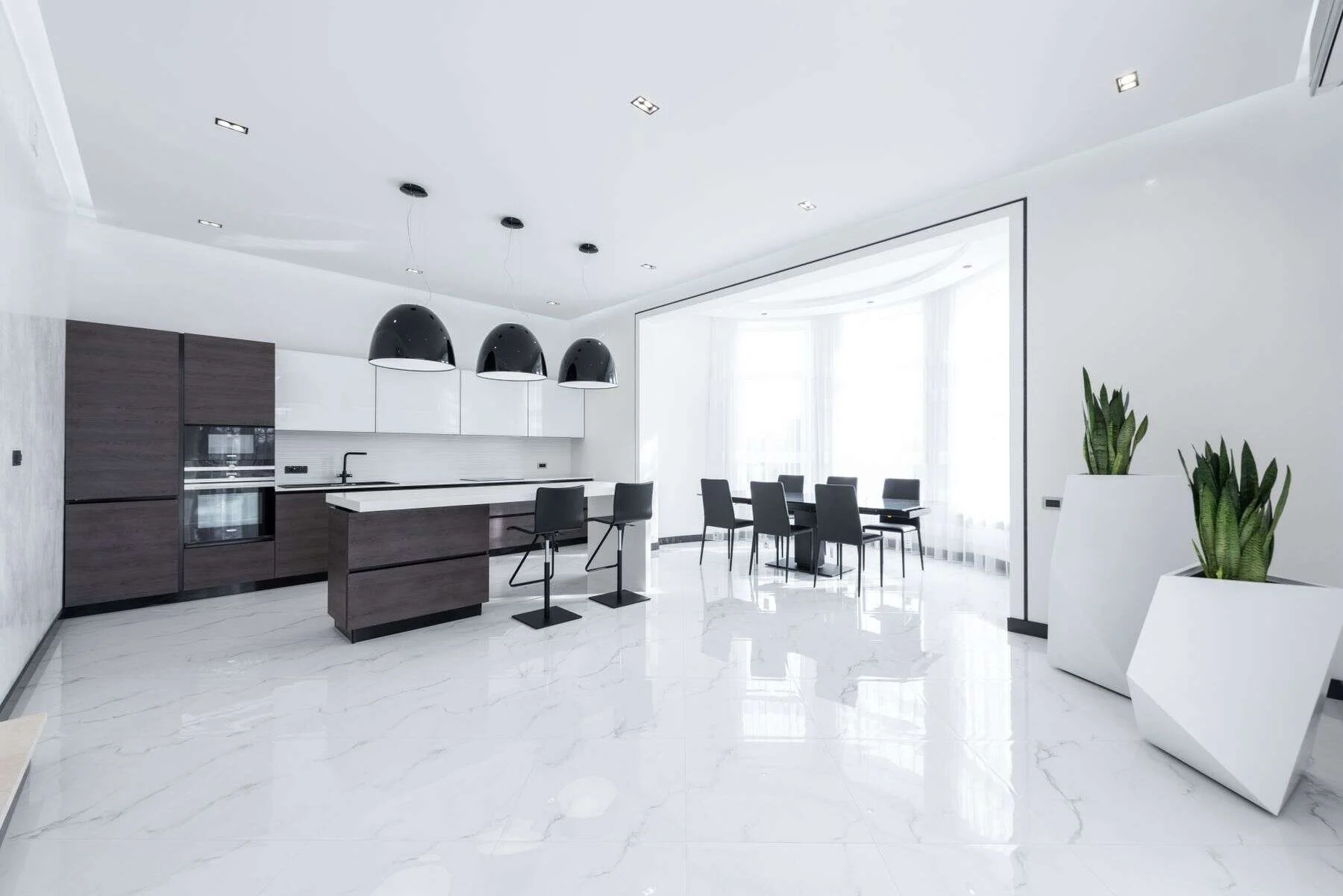 Spacious modern kitchen with a glossy marble floor