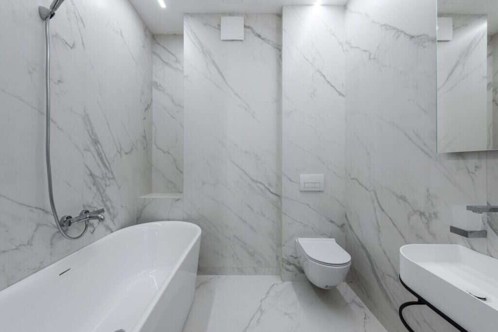 Bright bathroom with white veined marble walls