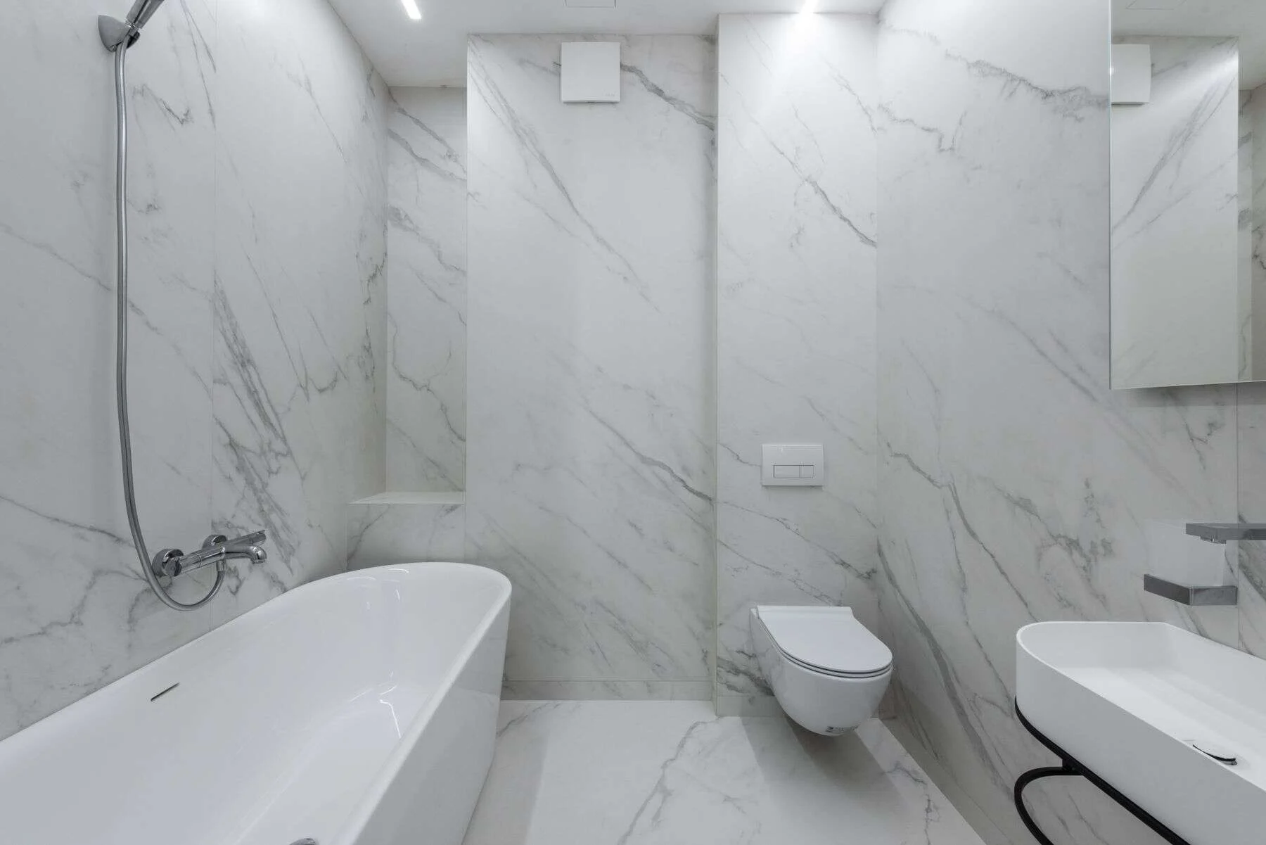 Bright bathroom with white veined marble walls