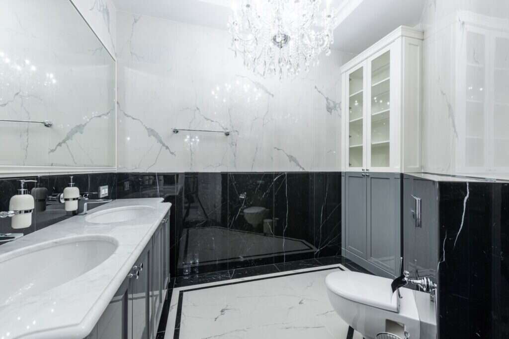 Bathroom with white marble walls and black marble base