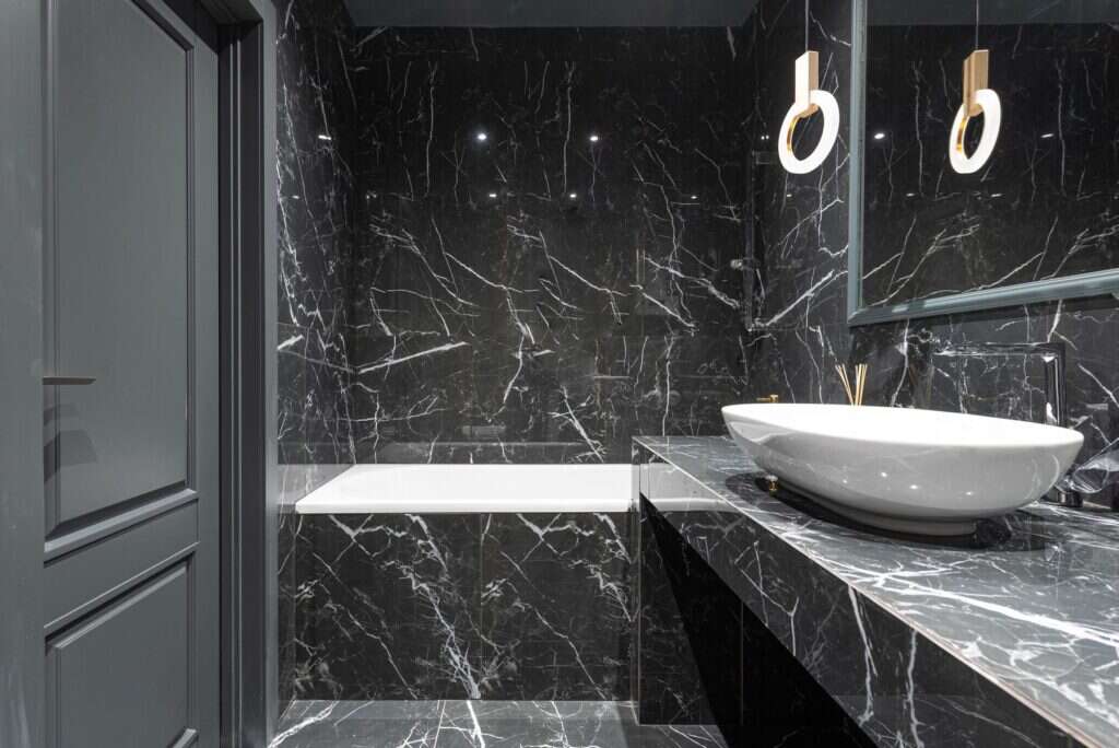 Black marble bathroom with a vessel sink