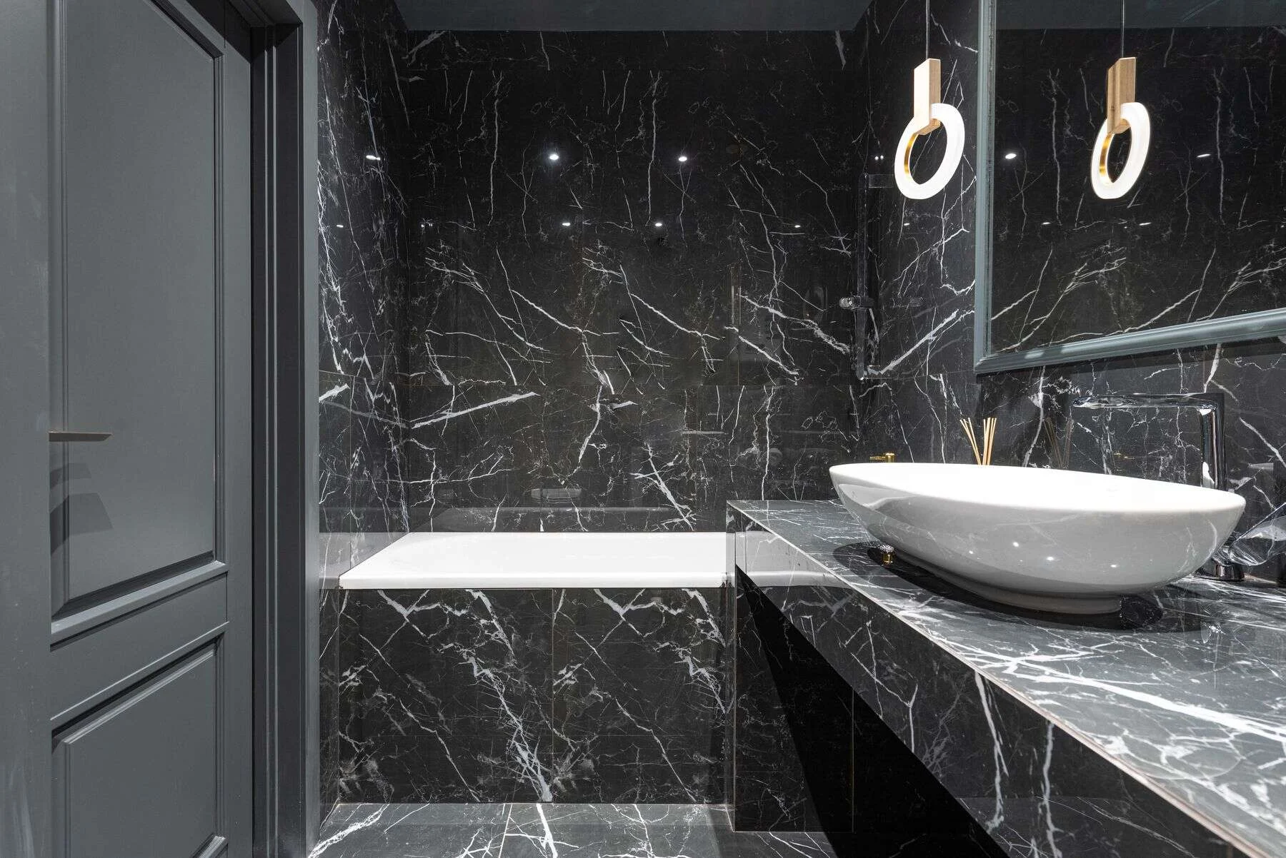 Black marble bathroom with a vessel sink