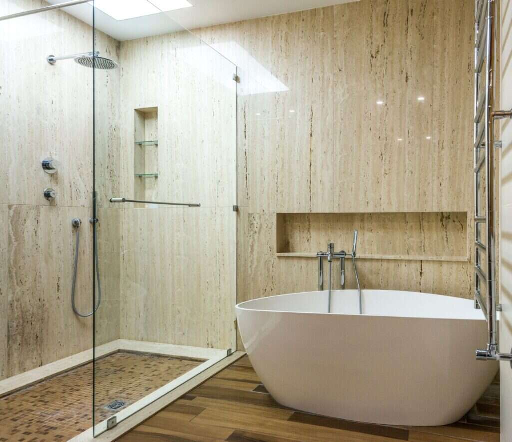 Travertine stone bathroom with a freestanding bath
