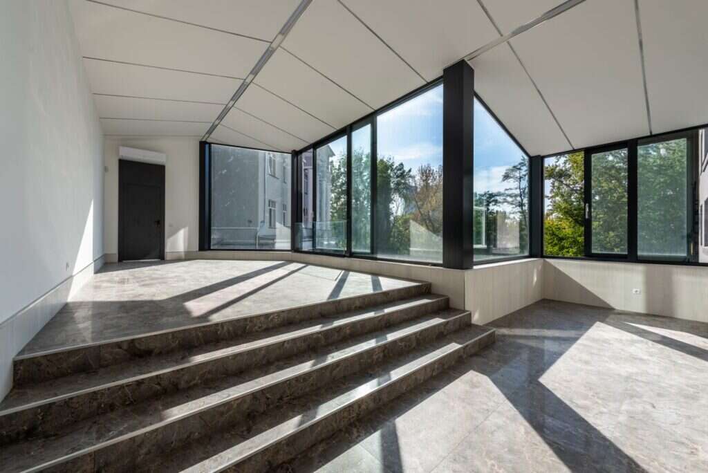 Polished stone steps leading into a bright room