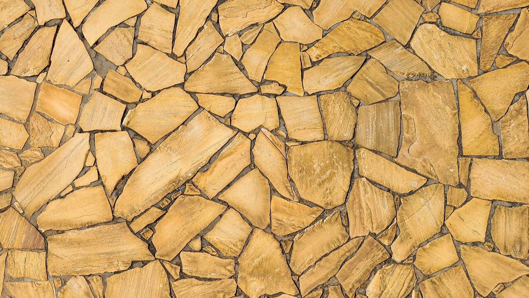 Yellow sandstone pieces laid as flooring